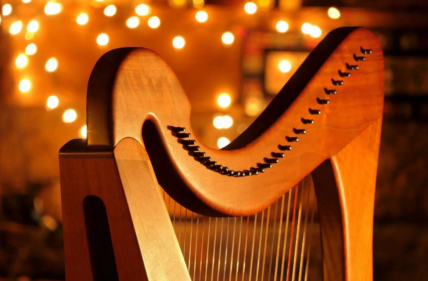 A harp lit by warm stage light.